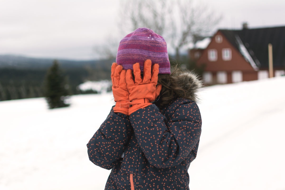 Little-girl-covers-her-face-in-winter.jpg